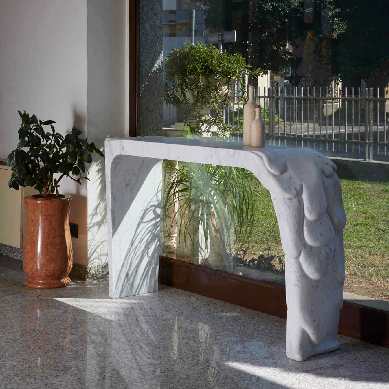 View of the console against natural lighting, accentuating the marble's reflective qualities and elegance.