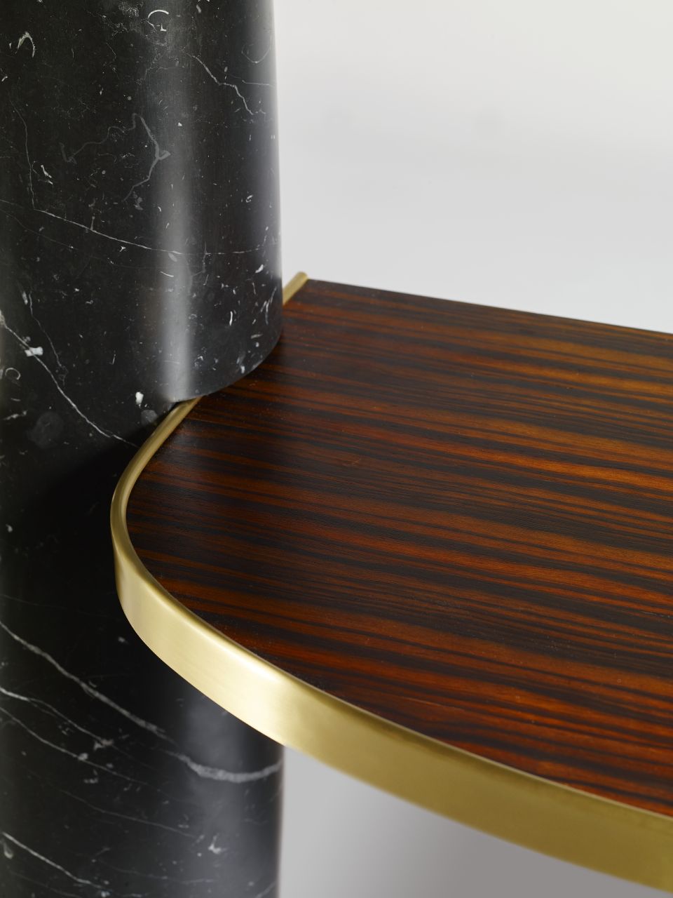 Focus on the contrasting textures of Nero Marquina marble and wood, highlighting their visual and tactile appeal.